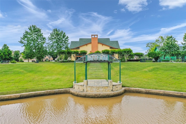 exterior space with a yard and a water view