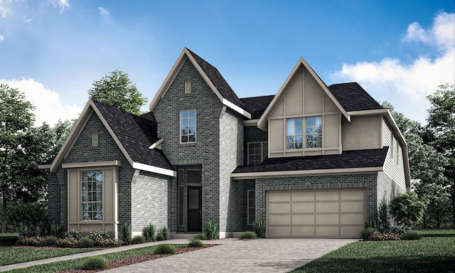 view of front of house with a garage, driveway, brick siding, and stucco siding