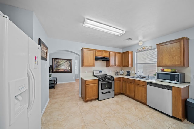 kitchen with sink, light tile patterned flooring, and stainless steel appliances