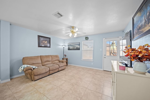 tiled living room with ceiling fan