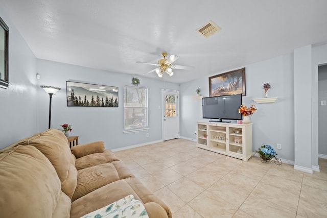 tiled living room featuring ceiling fan