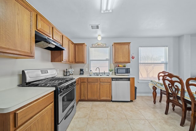 kitchen featuring sink, stainless steel appliances, and light tile patterned floors