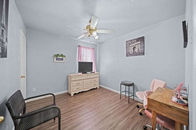 living area featuring ceiling fan and light hardwood / wood-style flooring