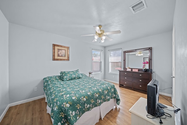 bedroom with ceiling fan and light hardwood / wood-style floors