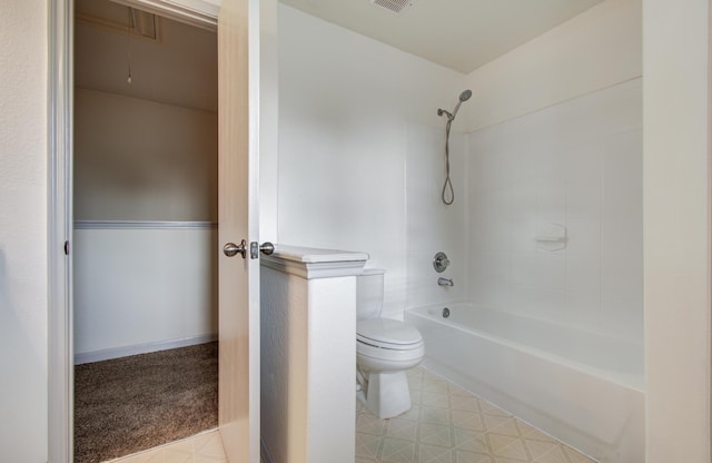 bathroom featuring shower / tub combination and toilet