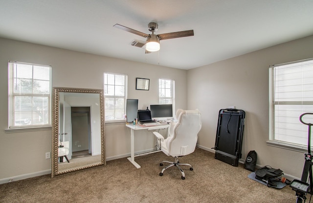 carpeted home office with ceiling fan