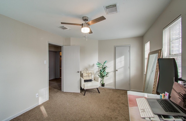 interior space with light colored carpet and ceiling fan