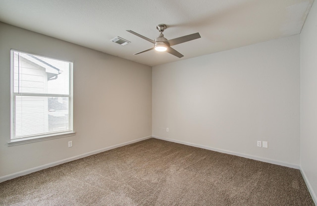 empty room featuring ceiling fan and carpet floors