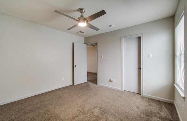 unfurnished bedroom featuring a closet, ceiling fan, and carpet floors