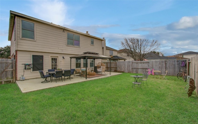 rear view of house with a lawn, a patio, and a gazebo