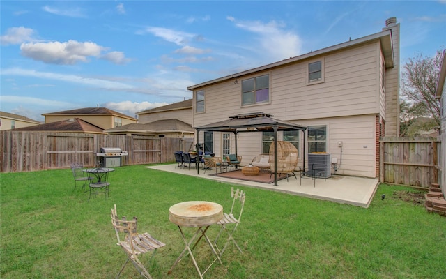 rear view of property with a yard, central AC unit, and a gazebo