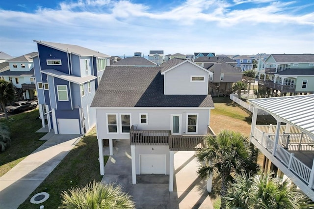 view of front of property featuring a garage and a balcony