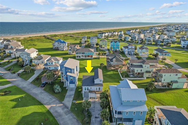 birds eye view of property featuring a water view and a view of the beach