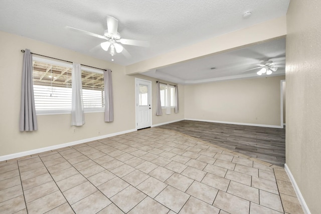 unfurnished room featuring a textured ceiling and ceiling fan