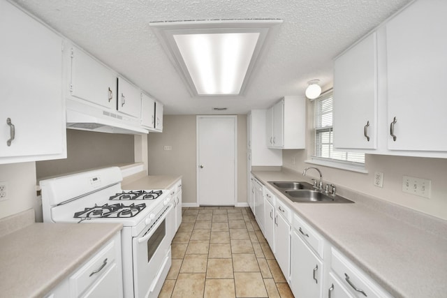 kitchen featuring sink, gas range gas stove, white cabinetry, and a textured ceiling