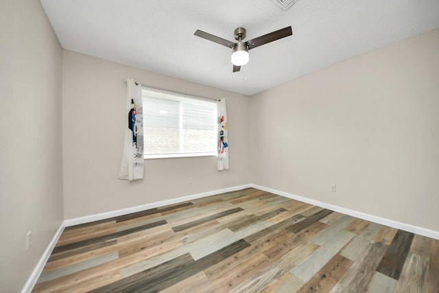 unfurnished room with hardwood / wood-style floors and ceiling fan