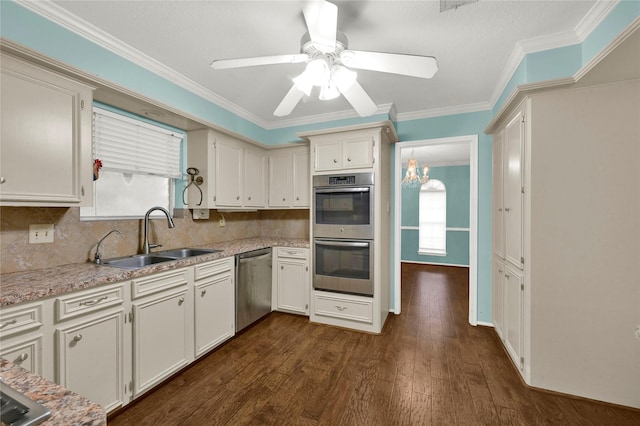 kitchen featuring white cabinetry, stainless steel appliances, sink, tasteful backsplash, and dark wood-type flooring