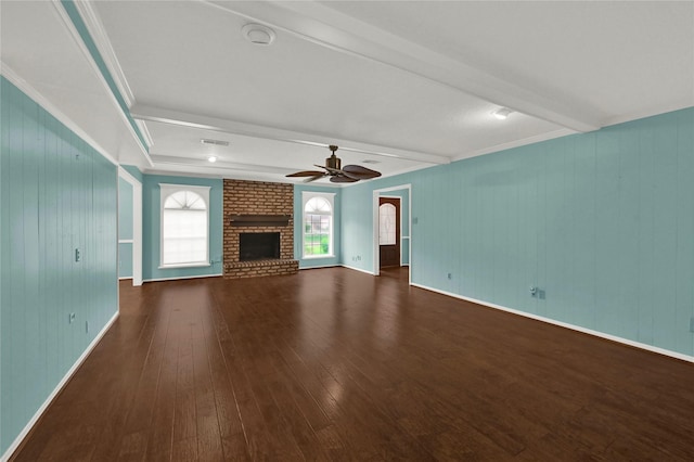 unfurnished living room featuring beam ceiling, ceiling fan, dark wood-type flooring, and a fireplace