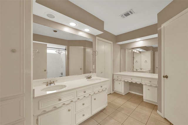 bathroom featuring tile patterned flooring and vanity