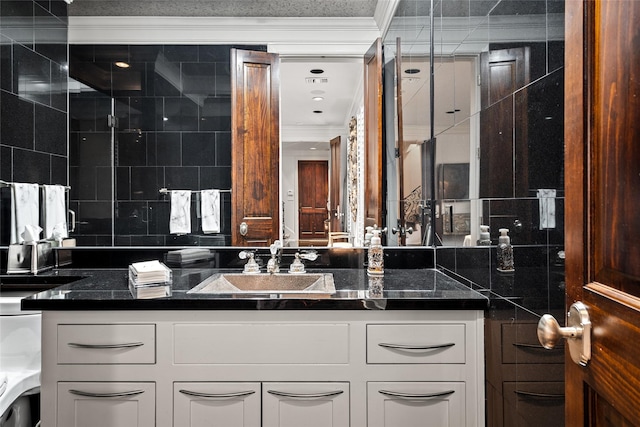 bathroom featuring tile walls, vanity, and crown molding