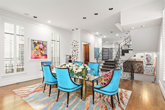 dining room with ornamental molding and wood-type flooring