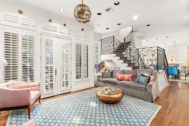 living room with light hardwood / wood-style flooring and crown molding