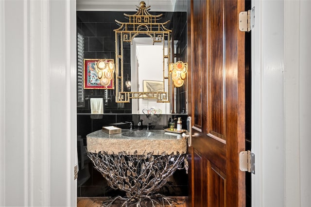 bathroom featuring backsplash, tile walls, and vanity