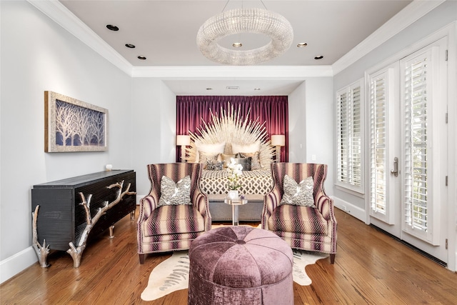 sitting room featuring ornamental molding and hardwood / wood-style floors