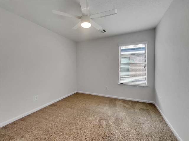 unfurnished room with ceiling fan and carpet floors