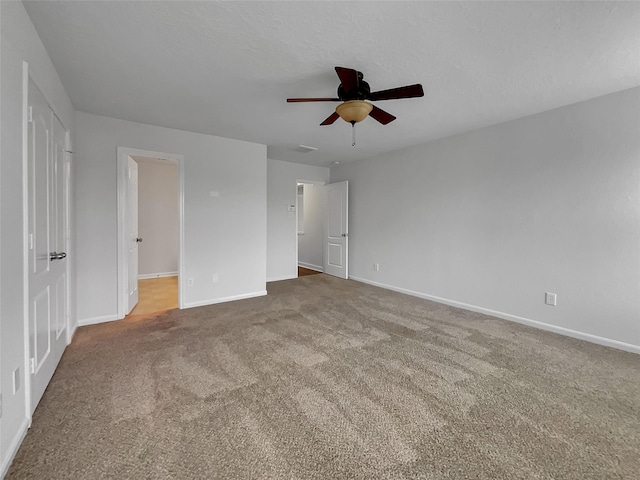 unfurnished bedroom featuring a textured ceiling, carpet flooring, and ceiling fan