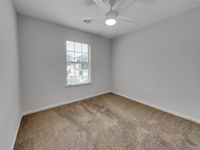 carpeted spare room with ceiling fan