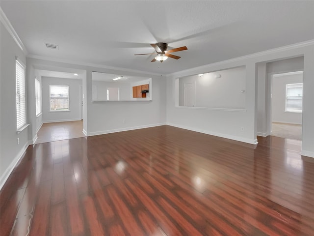 unfurnished living room featuring dark hardwood / wood-style flooring, ceiling fan, and crown molding