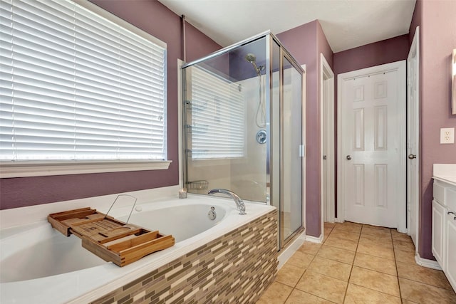 full bath with a stall shower, vanity, a bath, and tile patterned floors