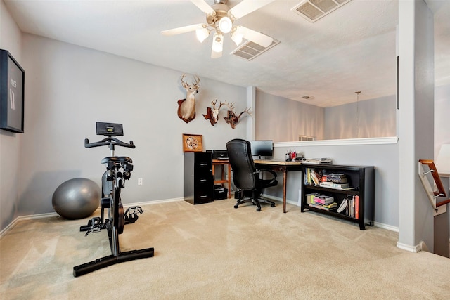 carpeted home office with visible vents, ceiling fan, and baseboards