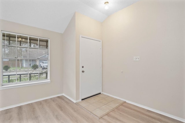 entryway featuring light hardwood / wood-style flooring and lofted ceiling