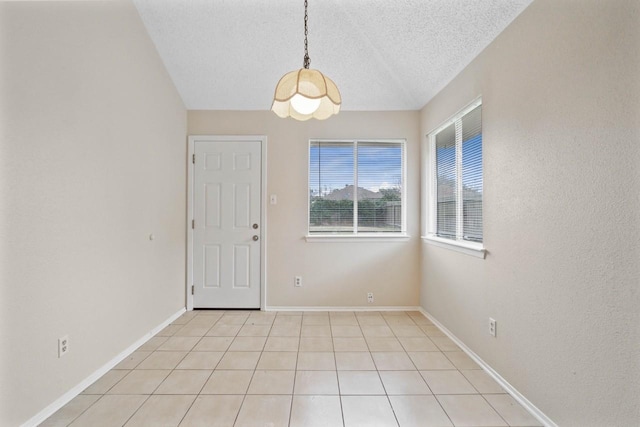 interior space featuring a textured ceiling and light tile patterned flooring