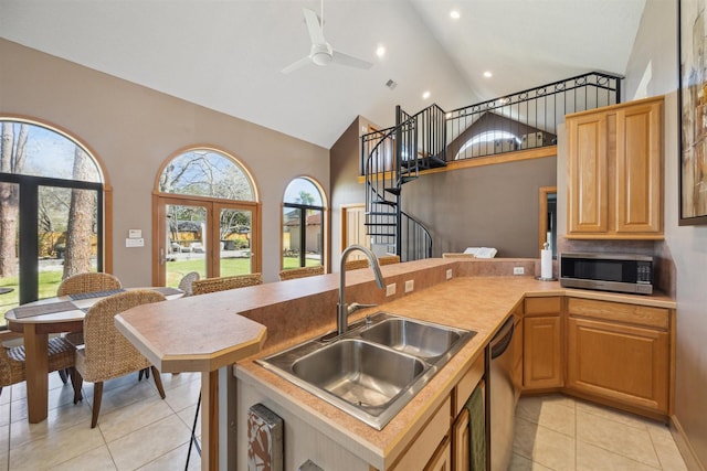 1004 Tall Pines Dr, Friendswood, TX 77546 - kitchen featuring stainless steel appliances, a sink, light tile patterned flooring, high vaulted ceiling, and a ceiling fan