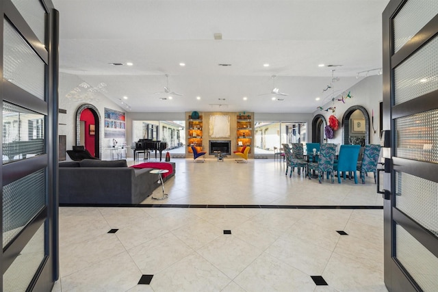 living room with lofted ceiling, ceiling fan, recessed lighting, and light tile patterned floors