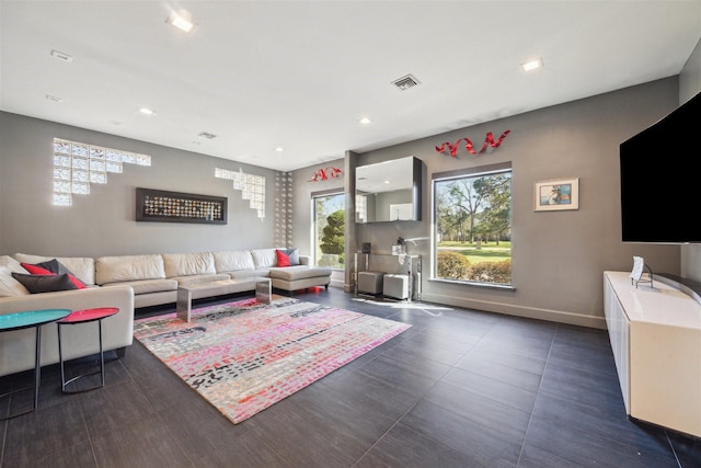 living room with recessed lighting, visible vents, and baseboards