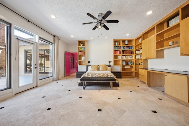 living area with recessed lighting, built in study area, ceiling fan, and a textured ceiling