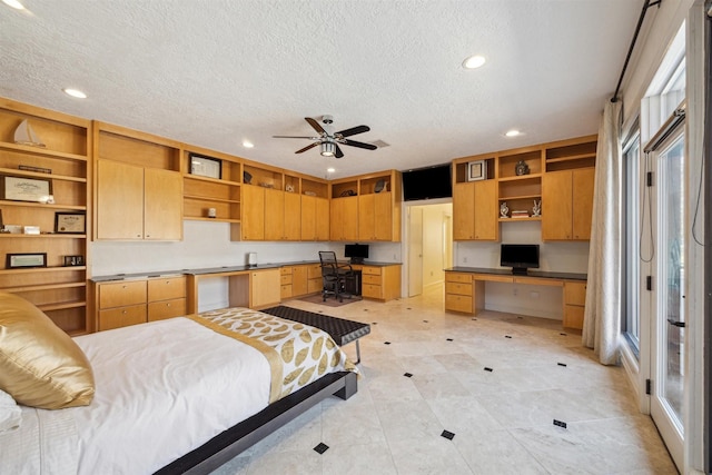 bedroom with recessed lighting, built in study area, and a textured ceiling