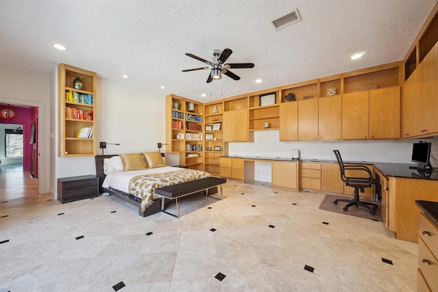 bedroom with a textured ceiling, built in desk, visible vents, and recessed lighting