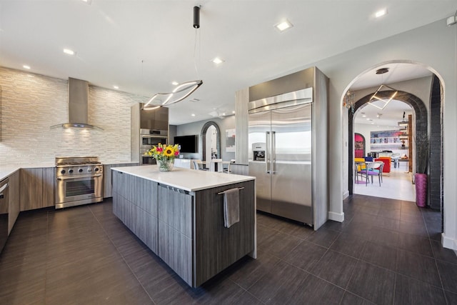 1004 Tall Pines Dr, Friendswood, TX 77546 - kitchen with modern cabinets, wall chimney range hood, high end appliances, light countertops, and recessed lighting