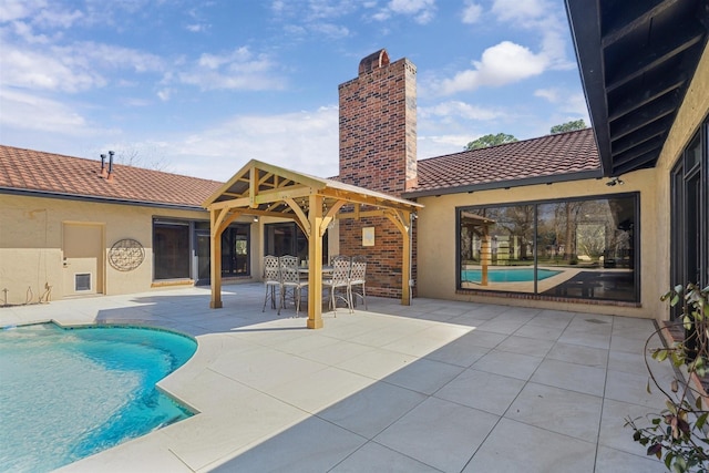 outdoor pool featuring a patio and a gazebo