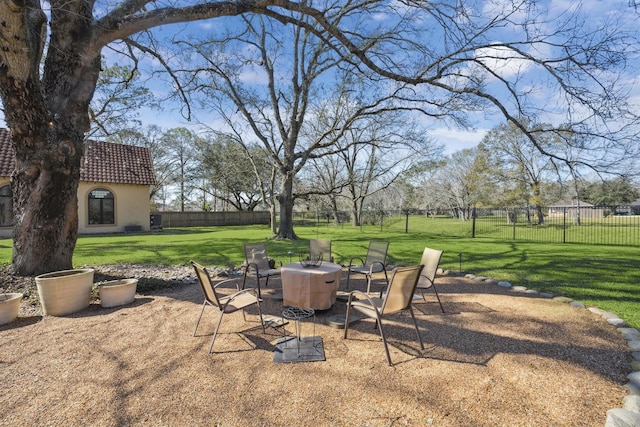 view of patio with an outdoor fire pit and fence