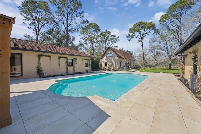 pool featuring an exterior structure, an outdoor structure, and a patio