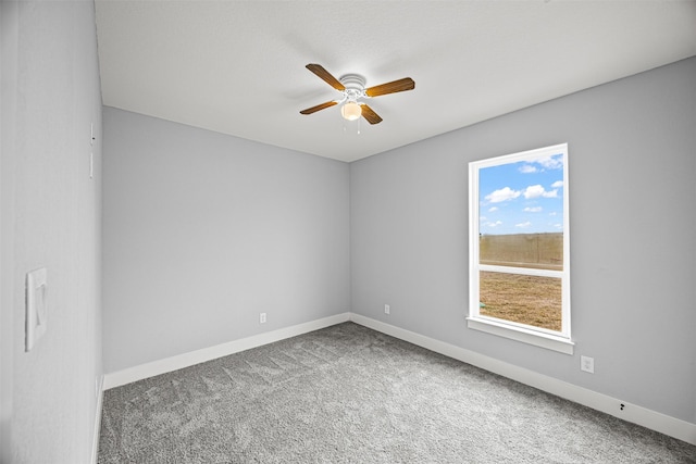 carpeted spare room featuring ceiling fan