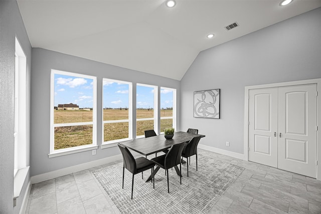 dining space featuring vaulted ceiling