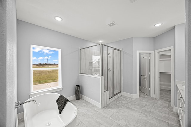 bathroom featuring plus walk in shower and vanity