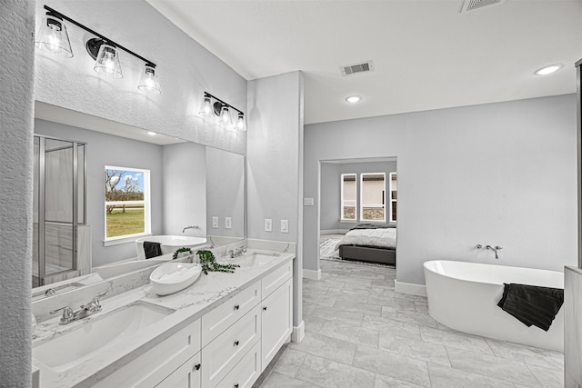 bathroom with a bath and vanity